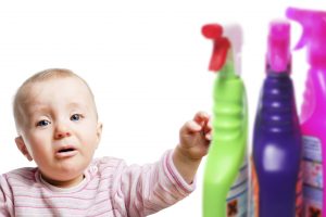 Infant child with cleaning chemicals